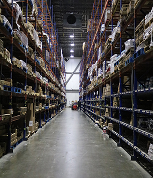 A long distance view of an aisle in an AGNE warehouse.