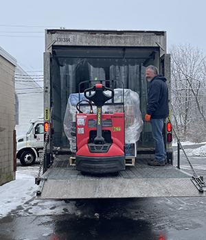 A forklift in the back of a box truck